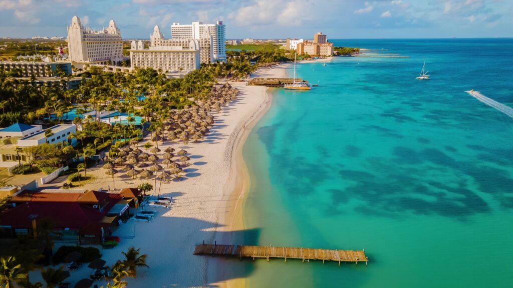 Top 6 Caribbean Cities to Visit This Summer - palm beach aruba caribbean white long sandy beach 2023 03 27 20 27 22 utc 1 , caribbean